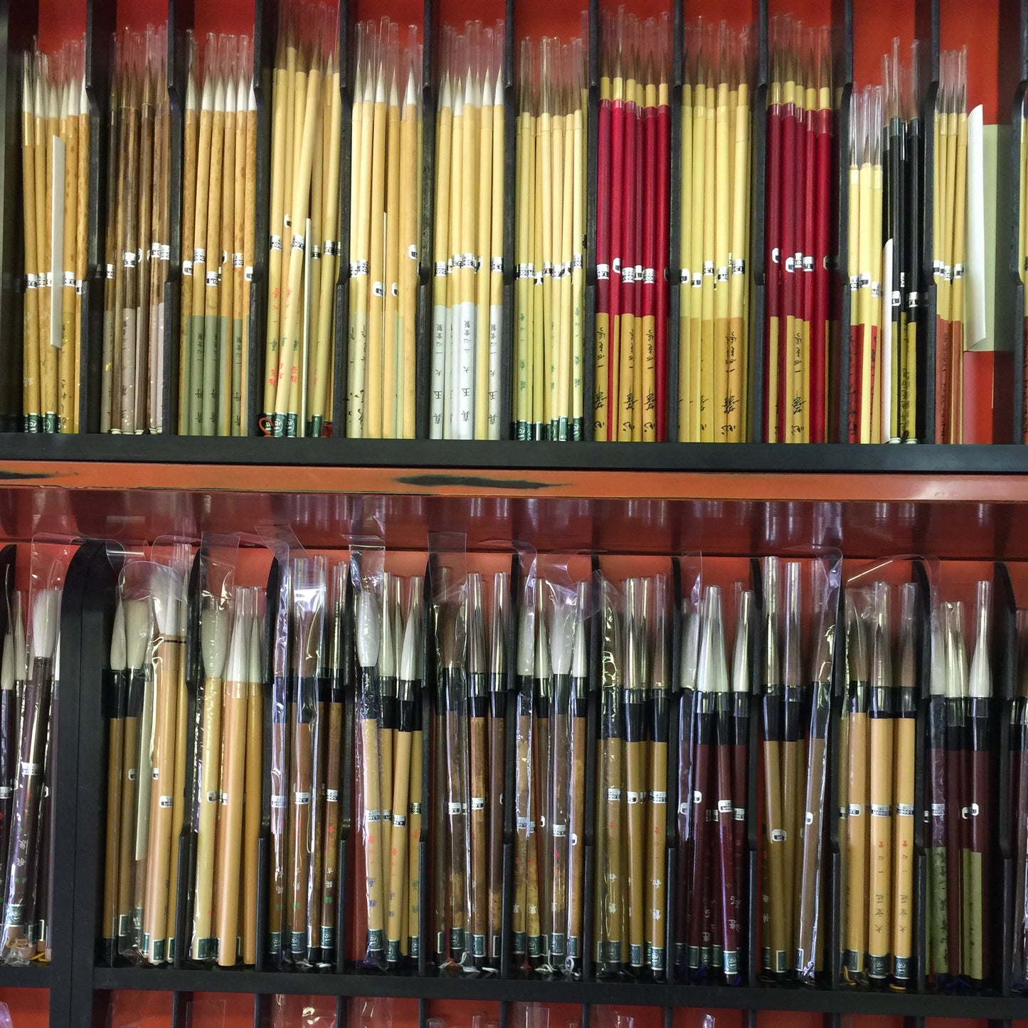 Collection of various paintbrushes in a display case