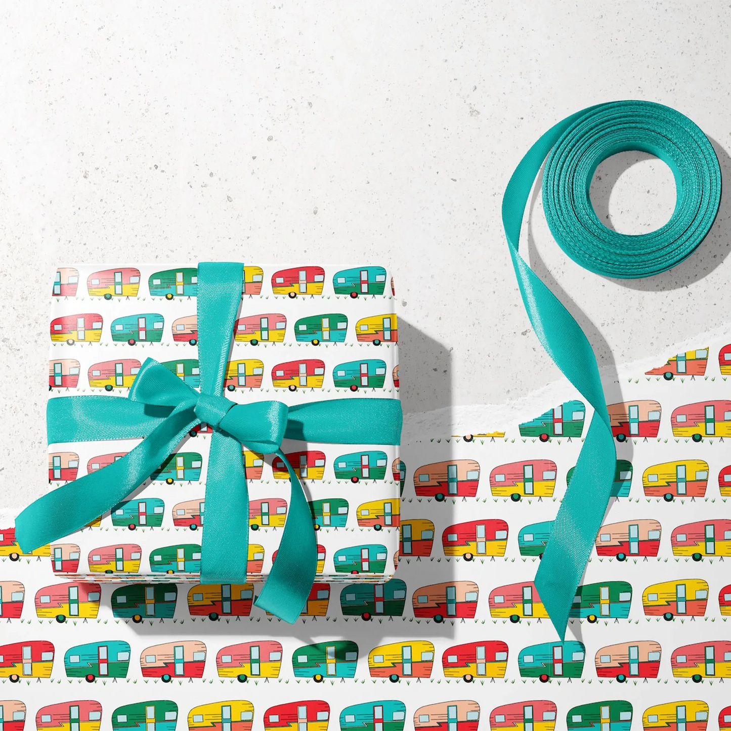 Hit the Road Wrapping Paper - Wrapped gift and roll of Hit the Road Wrapping Paper by Rebecca Jane Woolbright shown in a gift wrapping setup with teal ribbon