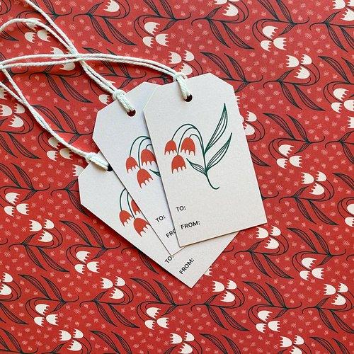 Dosado Red Gift Tags styled on matching red floral wrapping paper by Rebecca Jane Woolbright