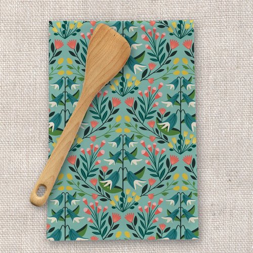 floral linen kitchen towel with a wooden spoon with a linen background