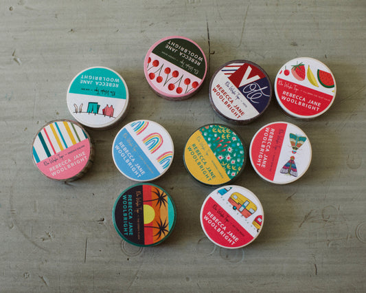 Colorful washi tape designs on a table designed by Rebecca Woolbright
