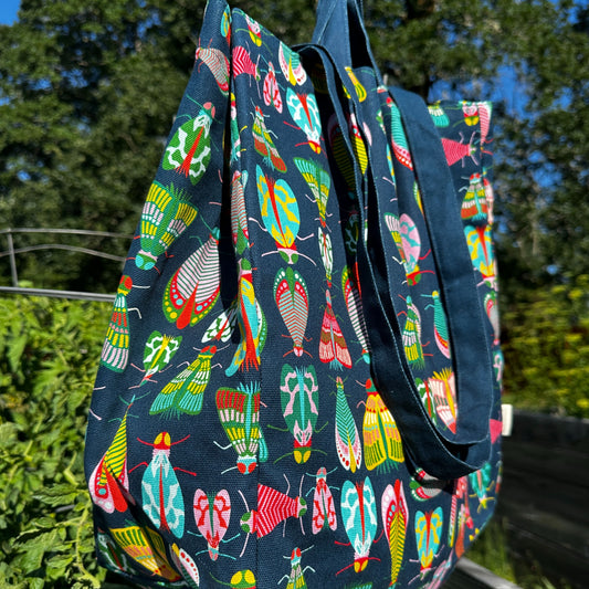 Bug cotton tote bag hanging in the garden