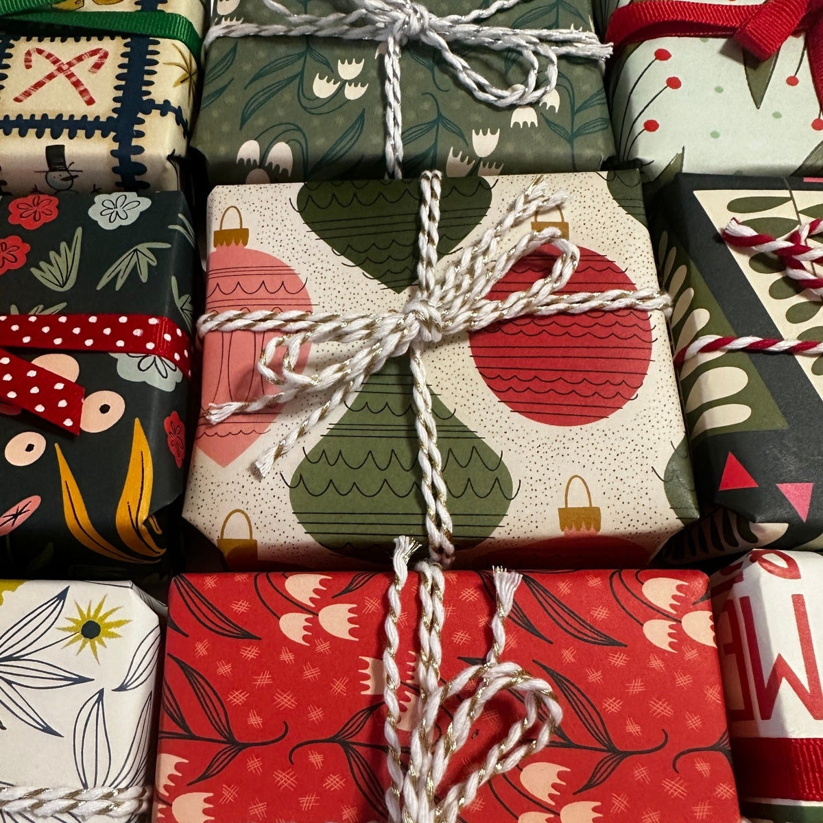 a bunch of small boxes wrapped in holiday wrapping paper