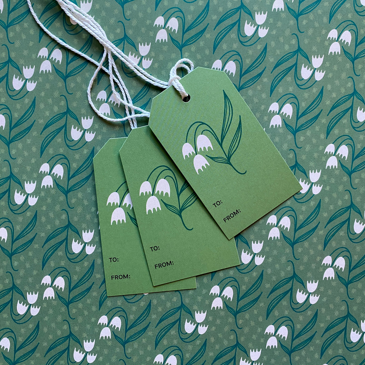 Dosado Green Gift Tag styled with matching green floral wrapping paper by Rebecca Jane Woolbright