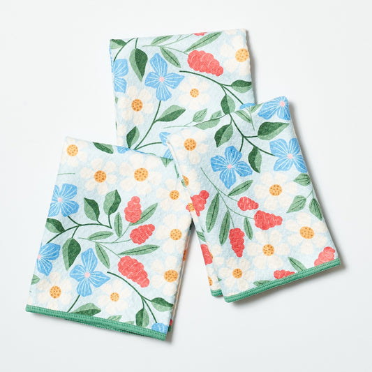 Set of three floral-patterned towels on a white background