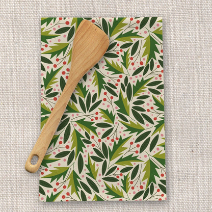 Patterned kitchen towel with wooden spoon on a textured surface