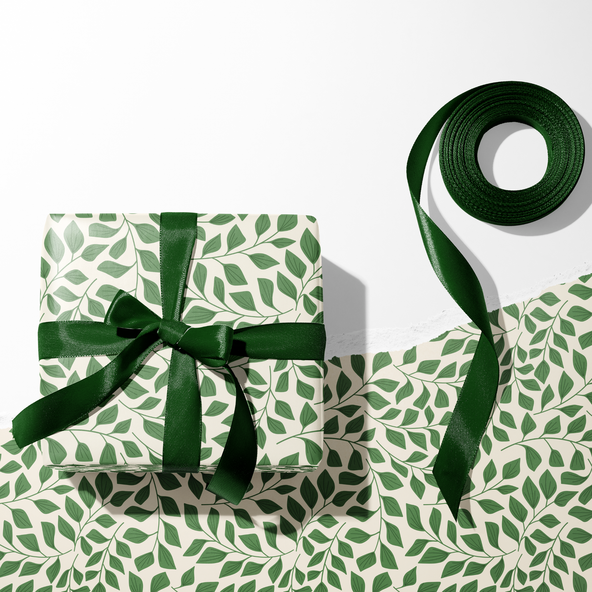 Green botanical wrapping paper sheets with matching ribbon roll, leafy gift wrap pattern for holidays and birthdays