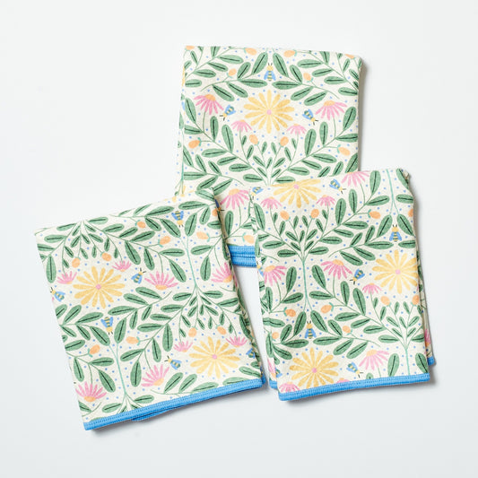 Set of three floral-patterned towels on a white background