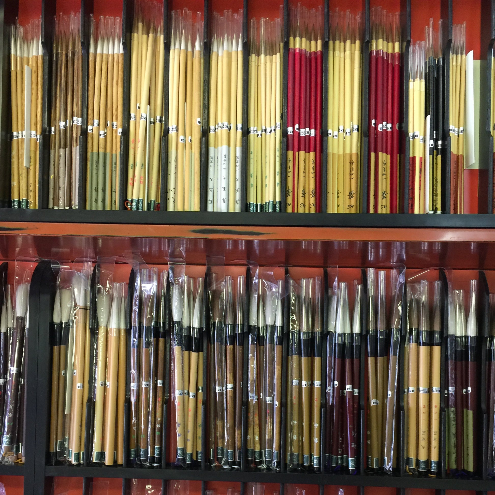 Collection of various paintbrushes in a display case