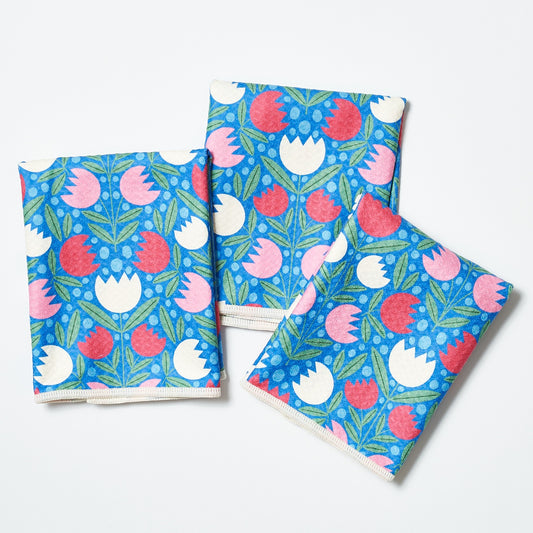 Set of three floral-patterned towels on a white background