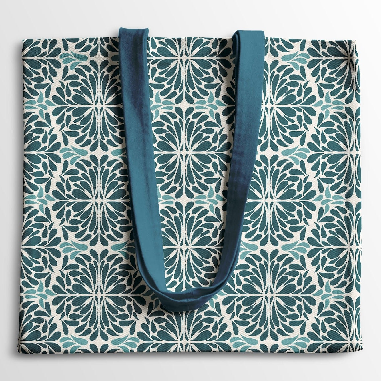 Tote bag with geometric pattern and blue handles on a light white background