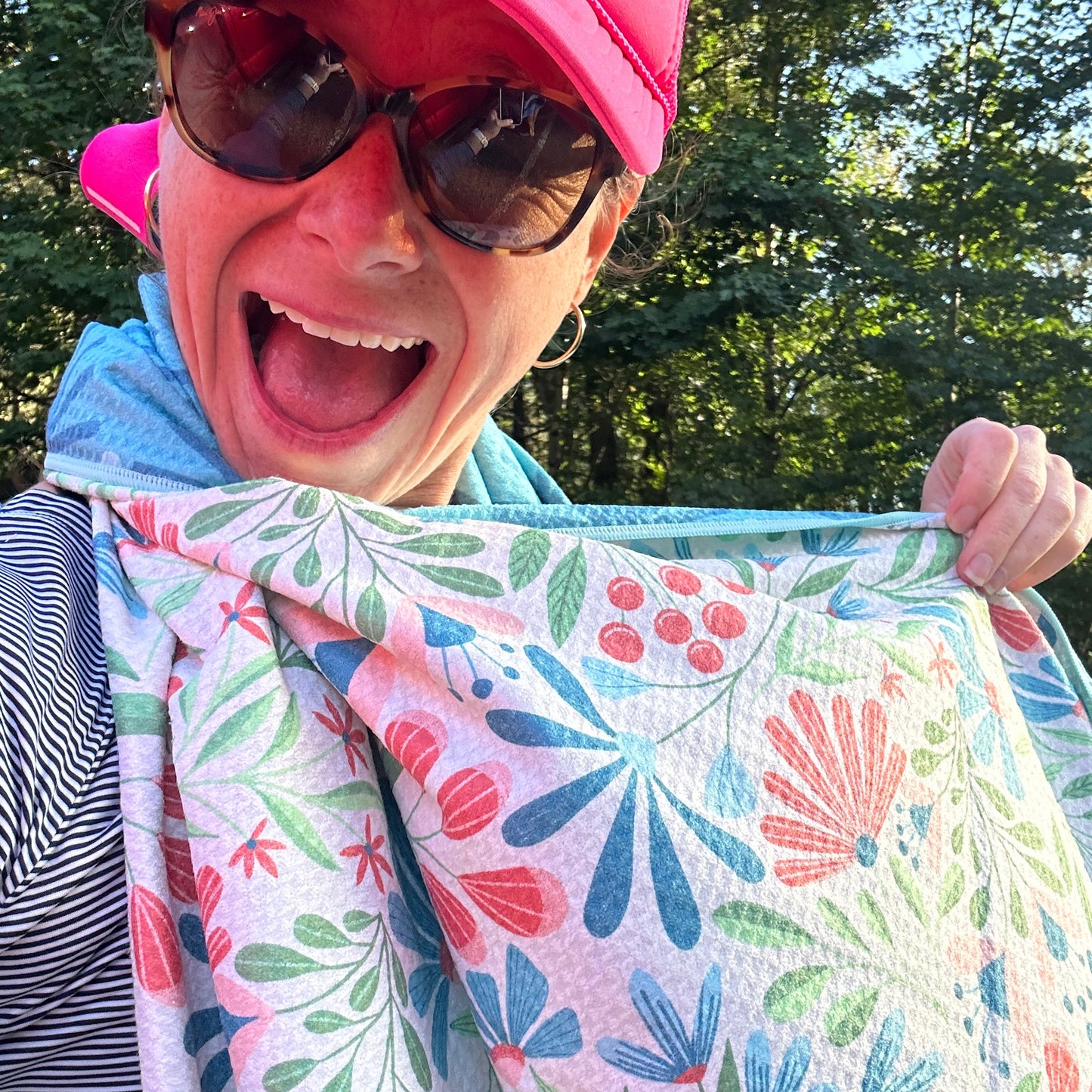 Person holding a floral-patterned towel outdoors