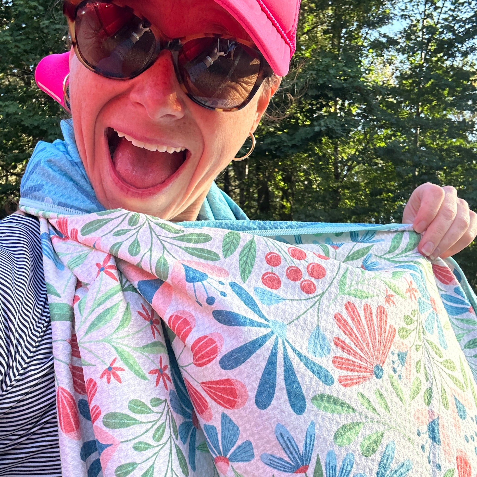 Person holding a floral-patterned towel outdoors