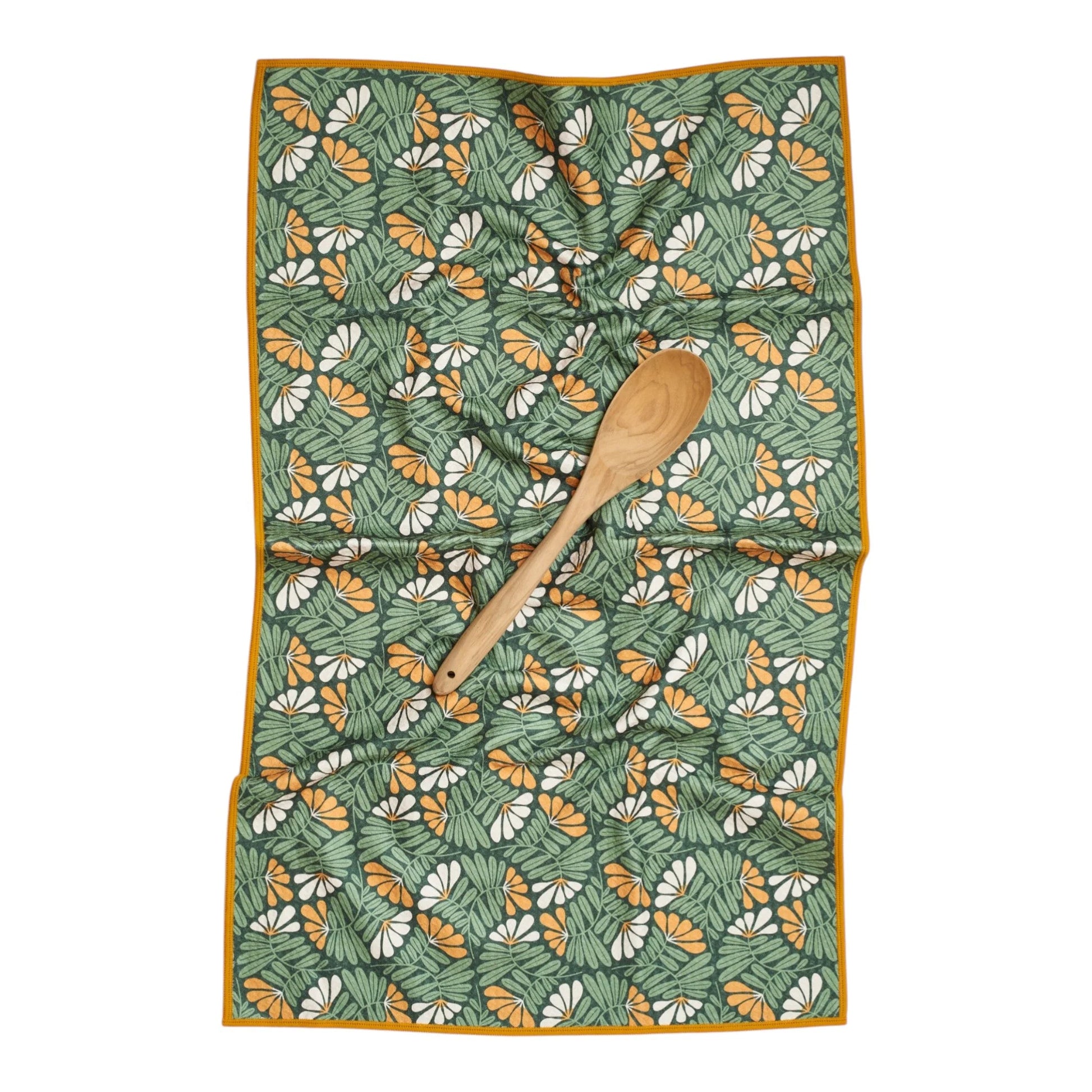 Floral patterned towel with a wooden spoon on a white background