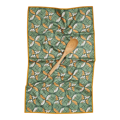 Floral patterned towel with a wooden spoon on a white background
