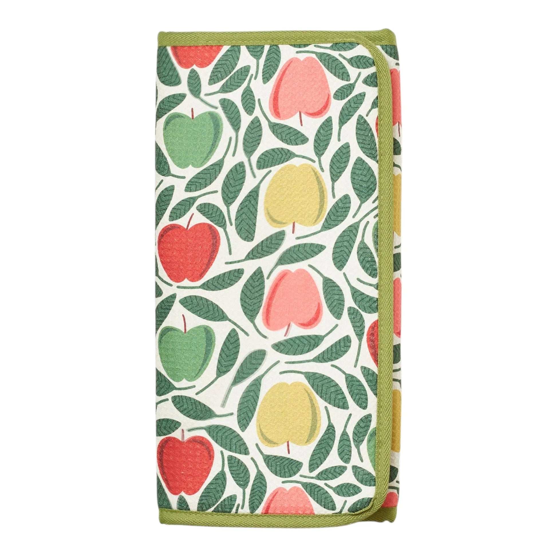 Folded dish mat with yellow apples with green leaves on a white background, finished with a light olive green trim.
