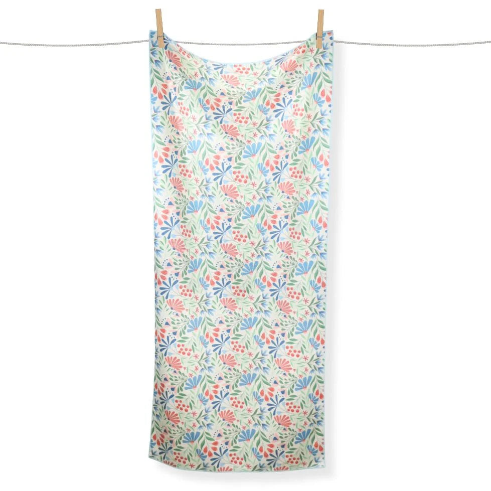 Floral patterned towel hanging on a clothesline against a white background