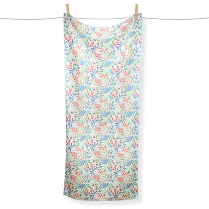 Floral patterned towel hanging on a clothesline against a white background