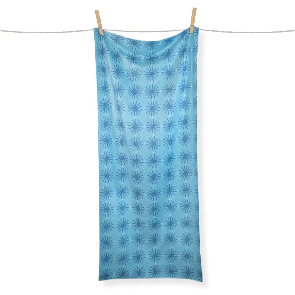 Blue patterned towel hanging on a clothesline against a white background