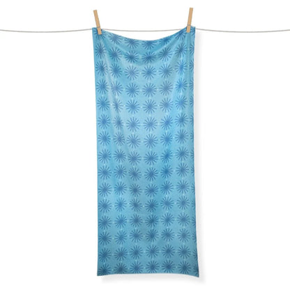 Blue patterned towel hanging on a clothesline against a white background